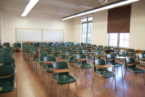 132 Mulford - Classroom Reservations - empty classroom with many green chairs