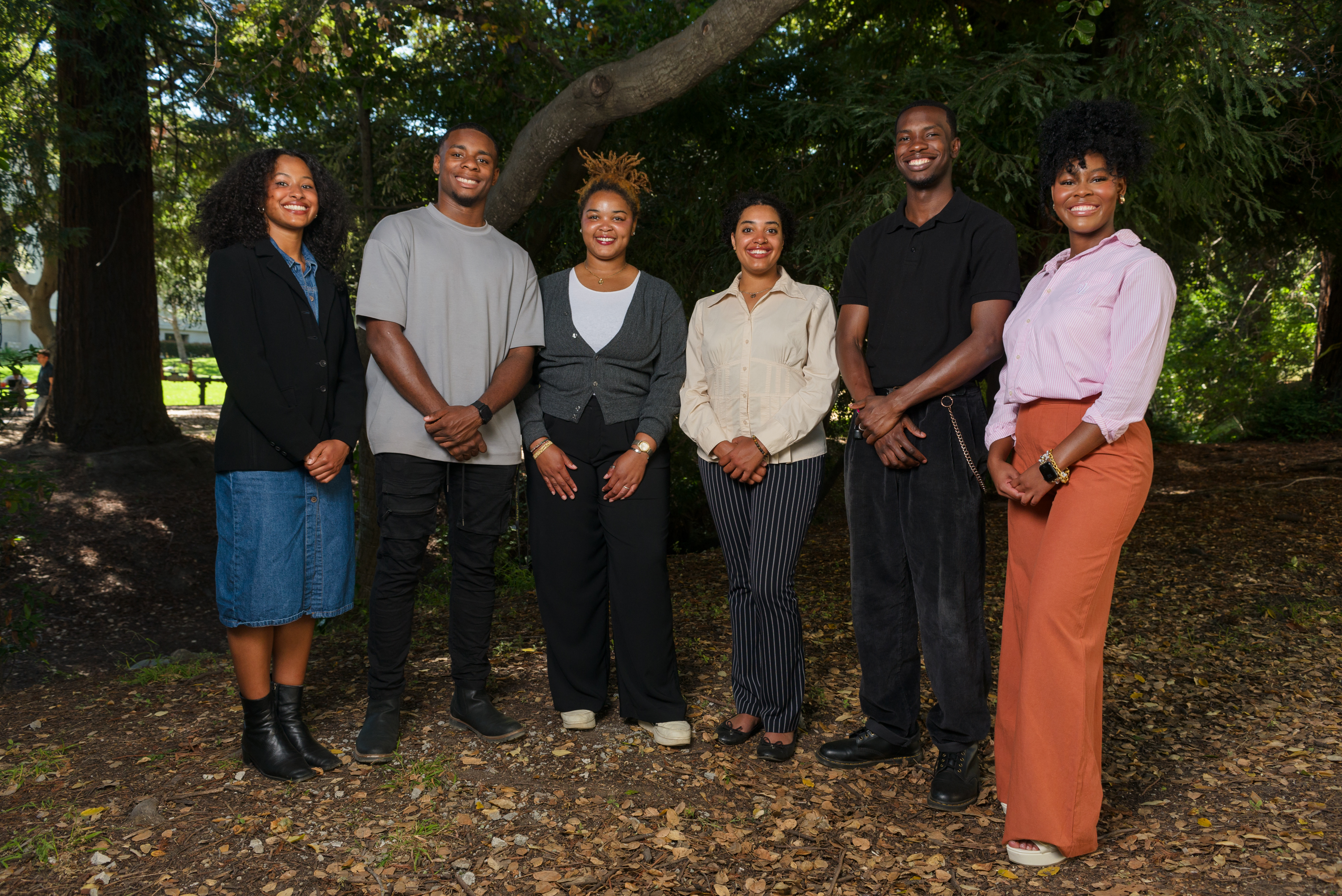 Six participants in the 2024 summer program standing under trees