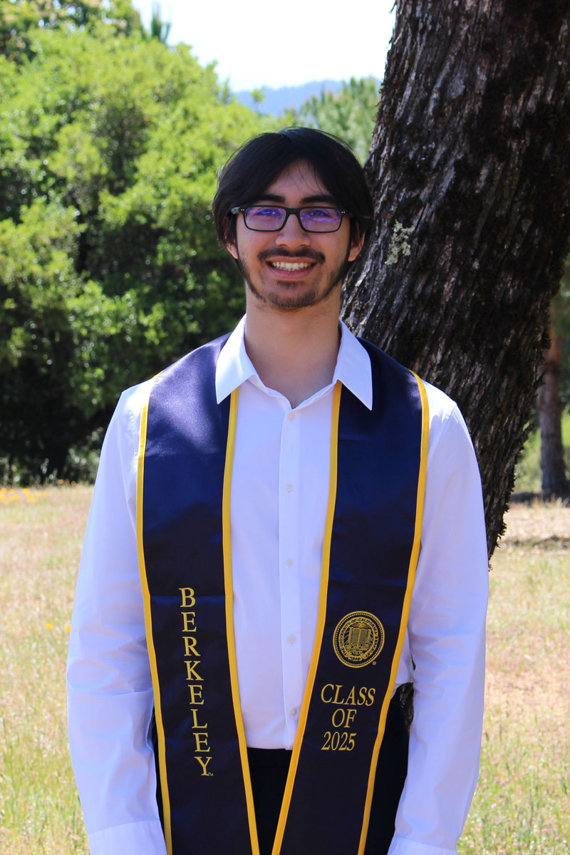 Neel Bajaria's graduation image in front of a tree