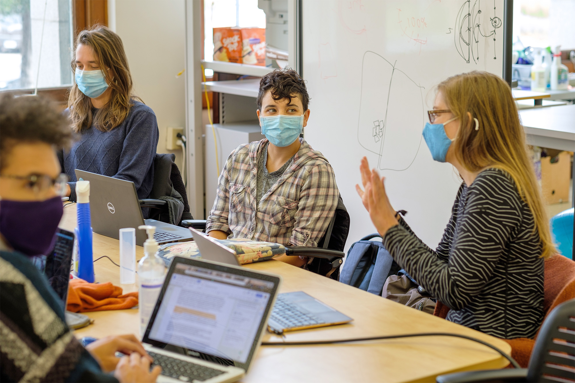 Students talking at a table.