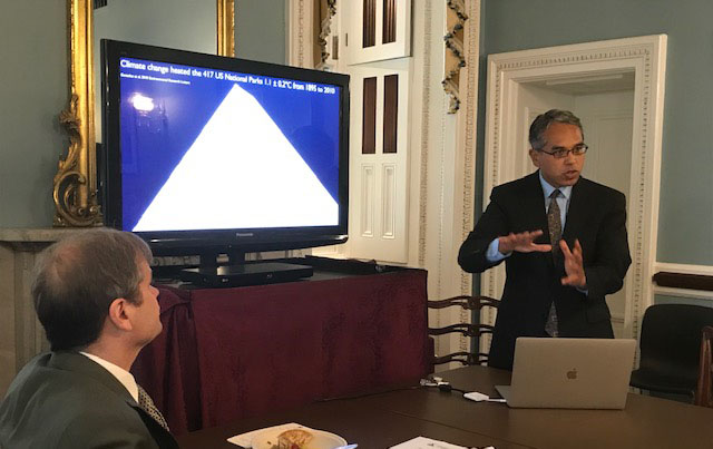 Dr. Patrick Gonzalez presents scientific findings to Representative Mike Quigley and other members of the congressional committee 