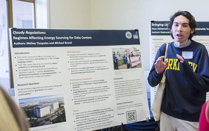 Image of Michael Brand presenting his research poster.