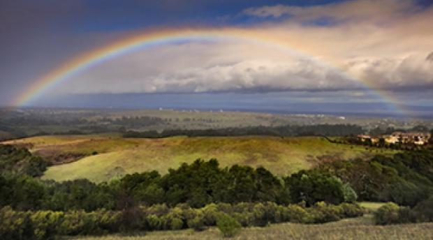 A rainbow over grasslands in California