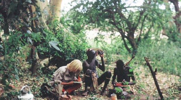  Carr documenting plant collections in the Omo Riverine forest in Ethiopia, with curious Dasanech men attending