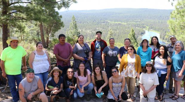 UC Berkeley researchers and Karuk Tribe members in front of panoramic view.