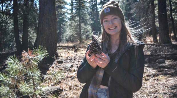 A photo of ESPM student Ashlyn Olah holding a pinecone