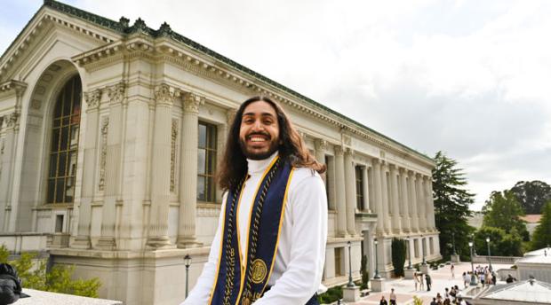 A graduation photo of Wanees Hannan in front of Doe Library