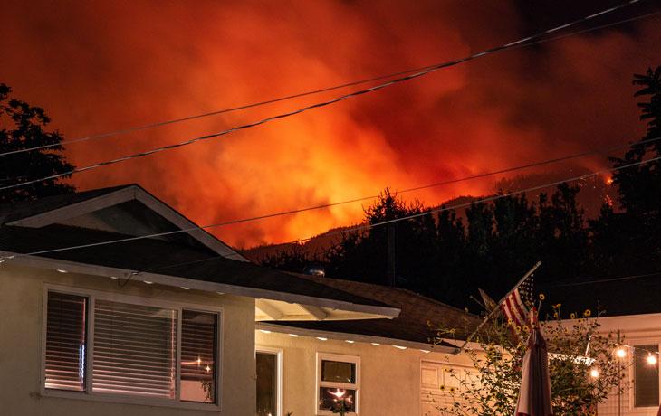 Image of wildfire within distance of residential area/house