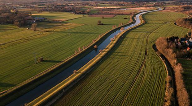 Water running through agricultural lands. 