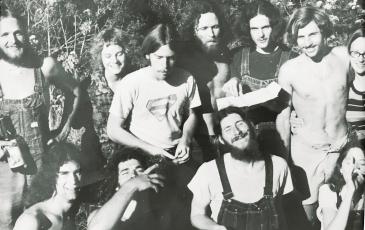 A black and white photo of a group of young people in the 1970s